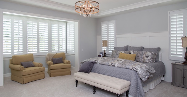 Plantation shutters in Honolulu bedroom.